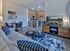Stylish open-concept living area featuring modern kitchen, cozy seating, and chic decor.
