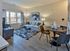 Bright living room with modern decor, featuring a cozy sofa, stylish dining area, and large window with natural light.