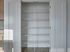 Empty pantry with white wire shelving and double doors, ideal for kitchen organization.