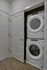 Efficient laundry nook with stackable washer and dryer in a modern apartment setting.
