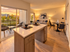 Stylish open-concept living area featuring modern kitchen, cozy seating, and chic decor.