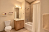 Contemporary bathroom featuring a stylish vanity, modern shower, and tasteful decor.