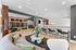 Stylish apartment common area featuring sleek mailboxes, modern seating, and elegant decor in a bright, inviting space.