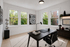 Bright, modern home office with sleek desk, large windows, and stylish decor.
