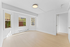 Bright and airy room with large windows, light wood flooring, and freshly painted walls, offering a welcoming and versatile space.