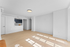 Bright and modern apartment living area with light wood flooring and a spacious open kitchen.