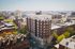 Charming urban apartment building rising elegantly above a picturesque cityscape, ideal for vibrant city living.