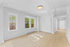 Bright and airy room with large windows, sleek wooden floors, and white walls, offering a fresh and inviting atmosphere.