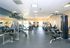 Modern fitness center featuring state-of-the-art exercise equipment, ample natural light, and motivational decor.