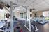 Bright and well-equipped gym featuring state-of-the-art machines and weightlifting equipment, perfect for a dynamic workout experience.
