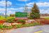Charming entrance view of The Green at Chevy Chase luxury apartments, highlighted by vibrant tulips and lush greenery.