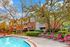Inviting apartment community with lush greenery and a sparkling swimming pool, perfect for relaxation and leisure.