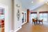 Bright and inviting dining area with elegant wall decor, featuring large windows and modern furnishings.