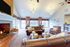 Elegant living room with cozy fireplace, stylish leather seating, and large windows offering natural light.