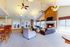 Elegant living room with high ceilings, cozy fireplace, and modern seating area, perfect for relaxation and entertaining.