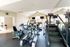 Bright and modern gym with state-of-the-art exercise equipment, large windows, and mirrored walls for an energizing workout experience.
