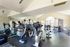 Bright and airy fitness center with modern exercise equipment and large windows for natural light.