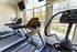 Bright and inviting fitness center with modern treadmills and elliptical machines, complemented by large windows offering scenic outdoor views.