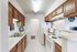 Bright and inviting kitchen with sleek appliances, abundant wooden cabinetry, and ample counter space for culinary adventures.