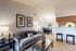 Inviting open-concept living space with a cozy sofa, modern decor, and dining area next to a stylish kitchen.