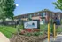 Charming brick apartment community with lush landscaping and inviting signage at Jenn Station Apartments.