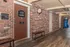 Inviting leasing office entrance with welcoming signage, brick walls, and a convenient vending area in a well-maintained corridor.