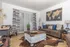 Bright, modern living room with a cozy brown sofa, chic coffee table, and artistic wall decor, blending comfort and style.