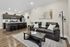 Contemporary open-concept living space featuring a cozy couch, stylish coffee table, and modern kitchen area.