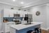 Sleek modern kitchen with white cabinets, stainless steel appliances, and a stylish blue tile backsplash.