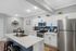 Modern kitchen with white cabinets, stainless steel appliances, and a stylish island with seating.