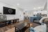 Bright and stylish open-plan living room featuring a modern kitchen, cozy seating area, and elegant decor.