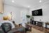 Inviting modern living room with plush leather sofa, sleek coffee table, and stylish decor.