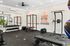 Modern home gym with weight racks, benches, and workout equipment.