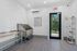 Bright and modern pet spa with a sleek washing station and tidy shelves.