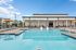 Inviting outdoor pool area with lounge chairs and umbrellas, ideal for relaxation.