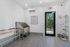 Chic pet spa room with grooming station, stylish white tiles, and outdoor access.