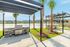 Charming outdoor grilling area with pergolas by a serene lakeside.