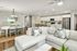 Elegant open-concept living area featuring a cozy L-shaped sofa, stylish kitchen with bar seating, and a welcoming dining space adorned with contemporary decor.