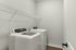 Modern laundry room featuring high-efficiency washer and dryer with sleek design and ample storage space.