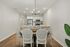 Chic open-concept kitchen and dining area with elegant seating, sleek stainless steel appliances, and modern lighting.