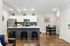 Chic modern kitchen with stylish island, stainless steel appliances, and cozy dining area, perfect for entertaining in a sleek open-concept apartment.