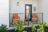Charming patio with cozy seating, vibrant cushions, and lush greenery, perfect for relaxation and outdoor enjoyment.