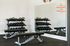 Modern fitness room featuring a well-organized set of dumbbells, kettlebells, and sleek workout benches, perfect for a dynamic exercise experience.