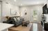 Inviting living room showcasing a sleek grey sofa, elegant wall decor, stylish lighting, and a bright patio view.