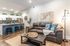 Modern open-concept living area with a cozy leather sofa, stylish kitchen island, and elegant lighting, perfect for relaxed gatherings.