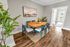 Spacious dining room with a table, chairs, and natural lighting.
