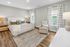 Spacious bedroom with natural light, neutral decor, king-size bed, and modern furnishings.