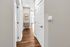 Well-lit interior hallway with clean lines, neutral walls, and modern flooring.