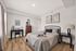 Cozy bedroom featuring a stylish bed with elegant pillows, warm lighting, and modern decor accents for a serene retreat.