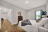 Inviting bedroom with modern decor, cozy bed, stylish artwork, and warm wooden furniture, offering a serene retreat.
